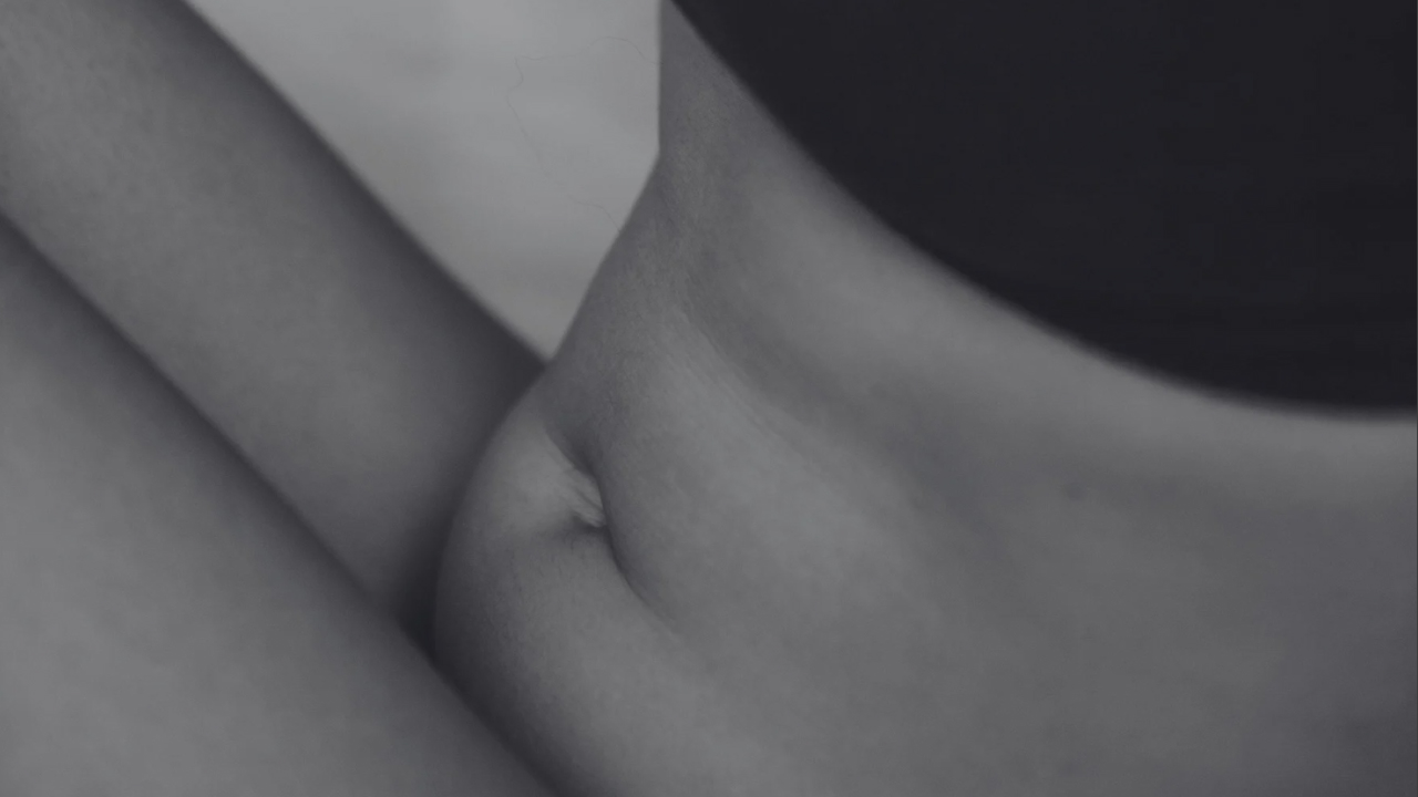 woman holding belly pooch related to pelvic floor health
