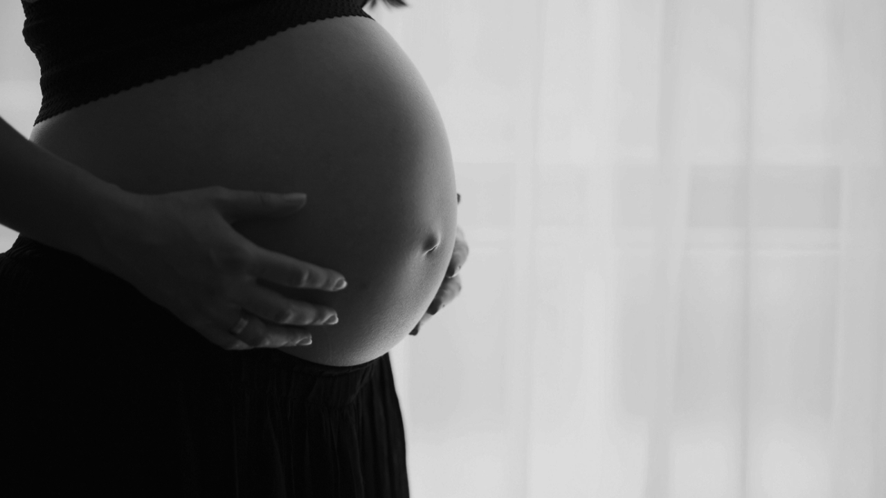 woman holding pregnant belly